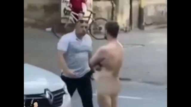 Naked protestor blocking traffic gets knocked the fuck out!